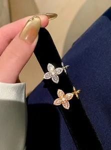 Macro view of two exquisite zircon star flower open rings in gold and silver finish.