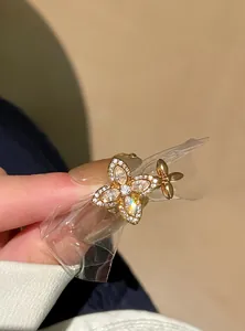 Close-up of elegant gold zircon flower open ring with sparkling crystal details.