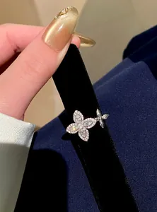 Detailed macro shot of a sparkling zircon flower star open ring displayed on black velvet.