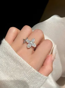 Detailed macro view of an elegant silver-tone flower ring set with sparkling zircons