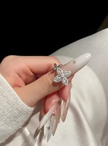 Elegant close-up view of a sparkling zircon star flower adjustable ring on a finger.
