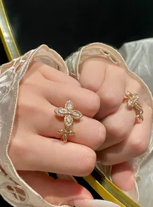 Detailed close-up of an elegant zircon star flower adjustable ring on index finger