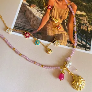 Close-up detail of floral charms and purple beaded necklace for a sweet summer look