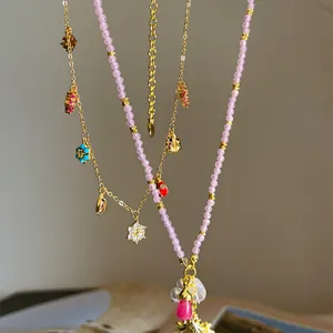 Close-up of sweet vacation style necklaces with colorful flower and snowflake charms
