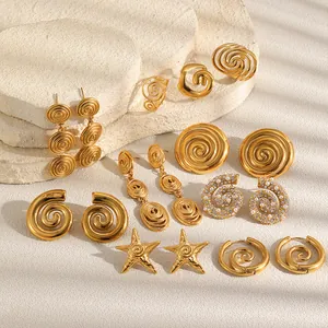 Close-up of golden stainless steel spiral and starfish earrings with pearl details