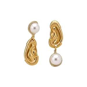 Elegant vintage gold earrings with asymmetric pearl and rhinestone ear-shaped design.