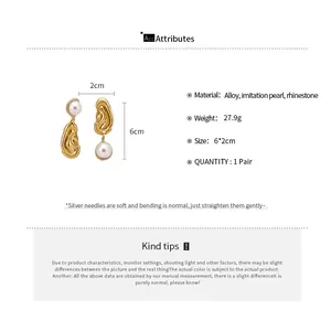 Detailed product view showing unique gold ear-shaped earrings with pearls and rhinestones