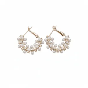 Elegant geometric hoop earrings with pearls and sparkling cubic zirconia.