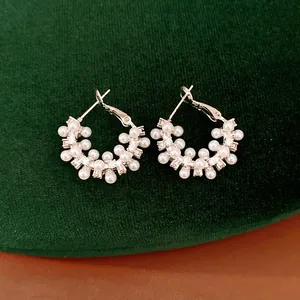 Detailed macro shot of elegant geometric pearl earrings with shimmering zircon