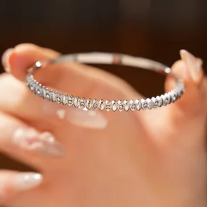 Exquisite macro detail of a stainless steel bangle featuring delicate inlaid zircons.