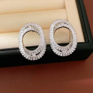 Close-up of elegant oval crossover earrings with baguette-cut cubic zirconia