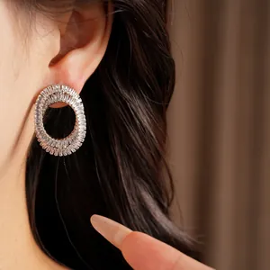 Close-up detail of luxury oval earrings inlaid with sparkling cubic zirconia stones