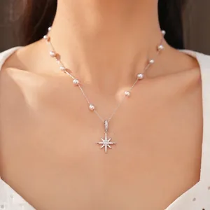 Elegant pearl necklace with zircon star pendant on female model