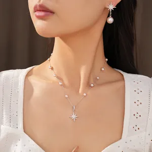 Elegant starburst zircon necklace and pearl drop earrings set shown on model