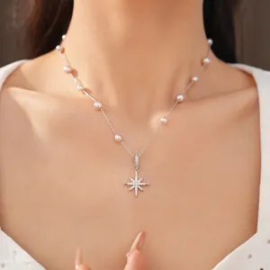 Detailed macro view of zircon-studded North Star pendant and pearls on elegant necklace