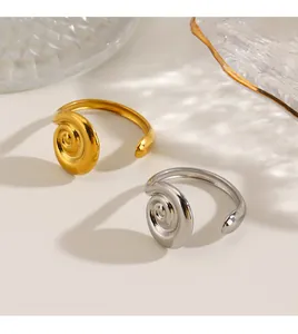 Detailed view of gold and silver stainless steel rings featuring a unique spiral texture