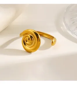 Close-up of a gold-plated stainless steel ring with a vintage spiral swirl design