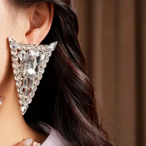 Glamorous oversized triangle silver earrings adorned with sparkling crystal diamonds
