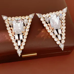 Luxurious triangle stud earrings with clear rectangular crystals and gold-tone setting