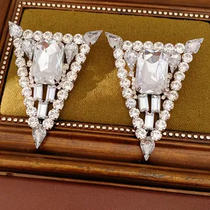 Detail of rhinestone triangle stud earrings with clear baguette and teardrop crystals