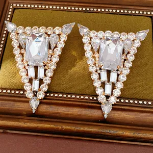 Close-up of luxury geometric triangle earrings featuring sparkling crystal rhinestones
