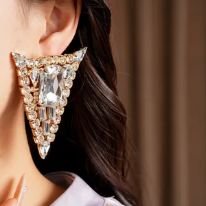 Close-up detail of geometric triangle earrings with sparkling crystal rhinestones