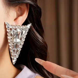 Close-up macro view of a luxury oversized triangular rhinestone silver post statement earring