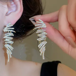 Detailed macro view of 18k gold plated geometric earrings with sparkling zirconia stones.
