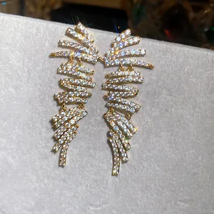 Macro view of luxurious 18k gold-plated geometric earrings with sparkling clear zircon