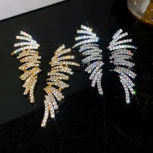 Detailed macro view of 18k gold-plated wing earrings with sparkling zircon stones