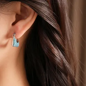 Elegant vintage silver hoop earrings with turquoise micro zircons shown worn on model ear