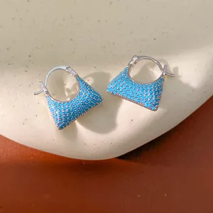 Detailed view of vintage square hoop earrings pavé-set with vibrant turquoise blue stones
