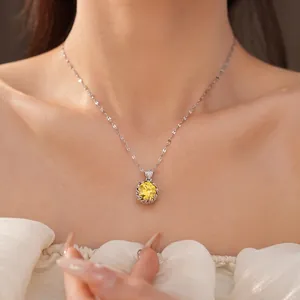 Exquisite silver necklace with a brilliant round yellow zircon pendant on a model