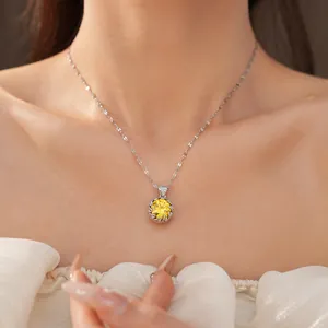 Close-up of elegant silver necklace with a brilliant round yellow zircon pendant