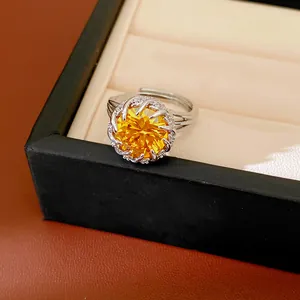 Elegant detail of a silver-toned ring featuring a large yellow round cubic zirconia
