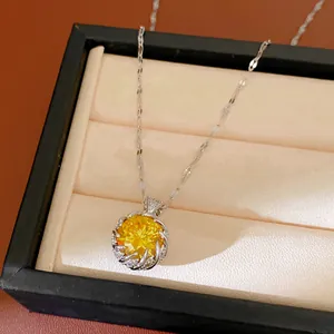 Detailed shot of an elegant silver necklace with a brilliant round yellow zircon pendant