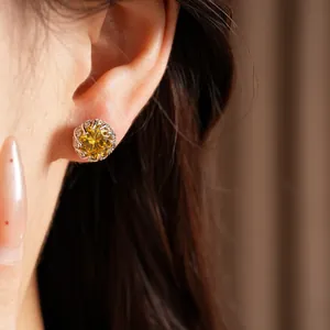 Elegant silver stud earring featuring a vibrant yellow round zircon shown on a model