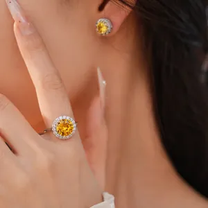 Close-up of elegant yellow zircon ring and stud earring set on an Asian female model