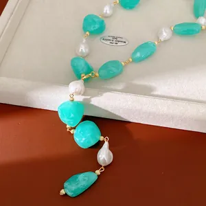 Detailed macro shot of irregular turquoise acrylic beads and white pearls on a necklace