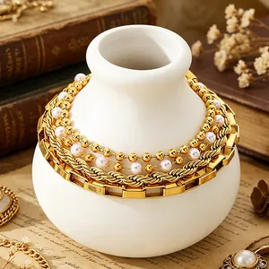 Elegant 18K gold plated titanium steel bracelet set with pearls on vintage background