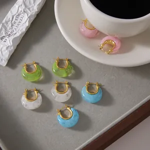 Detail view of macaron-colored resin hoop earrings with gold-plated stainless steel.