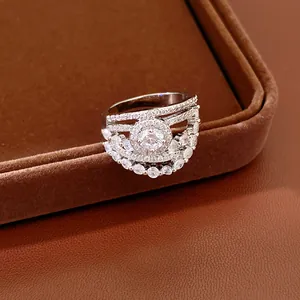 Close-up of a silver ring with hollow flower design and cubic zirconia stones