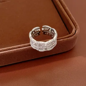 Macro view of exquisite silver hollow open ring set with sparkling zircons on jewelry tray