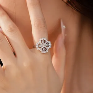 Close-up of a silver flower-shaped ring with zircon inlays and hollow water drop petals