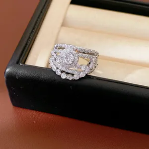 Close-up detail of silver hollow ring with sparkling zirconia flower and teardrop design