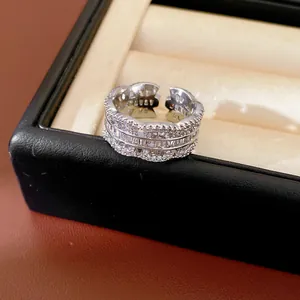 Macro detail of a high-quality zircon-inlaid silver open ring presented in a jewelry box