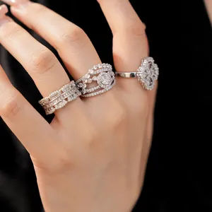 Detailed view of three exquisite silver rings with zirconia on a woman's hand
