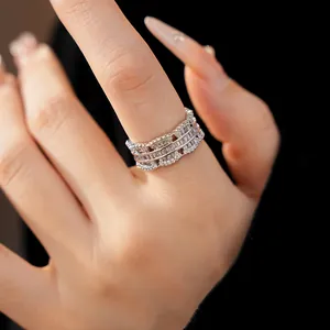 Detailed view of luxury silver hollow ring with sparkling zircon inlays on finger.