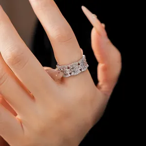 Detail shot of a silver-toned open ring with sparkling baguette and round zircons.