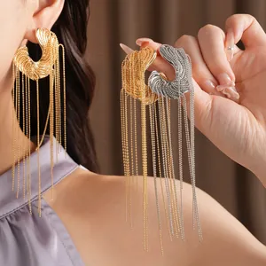 Detailed view of luxury irregular long tassel earrings in gold and silver finishes on model